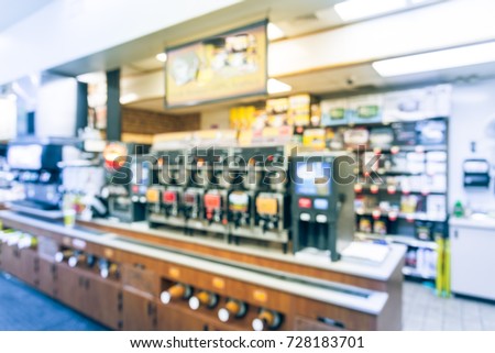 Blurred modern convenience store gas station in Arkansas, USA. Variety items on display such as impulse snack, energy drink, coffee, hot food, tobacco, cigarette, clothes, lottery ticket. Vintage tone