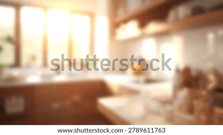 A blurred modern kitchen interior features warm sunlight streaming through a large window, illuminating the countertops and wooden shelves with a soft, inviting glow.