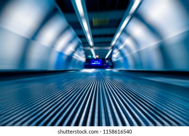 Blurred Motion Of Airport Moving Walkway, Blue Toned