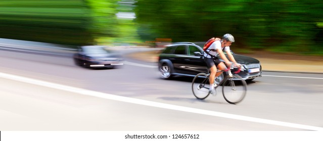 Blurred motion. Cyclist and car on the highway. Abstract background. - Powered by Shutterstock