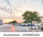 Blurred motion dramatic sunset cloud at uncovered parking lots of grocery store near Dallas, Texas, America.