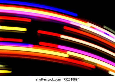 Blurred Motion Effect Around Of Brightly Illuminated Rotating High Speed Carousel