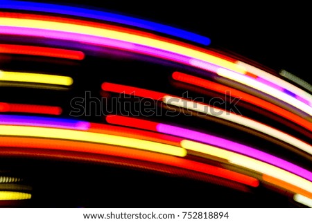 Blurred Motion Effect Around Of Brightly Illuminated Rotating High Speed Carousel