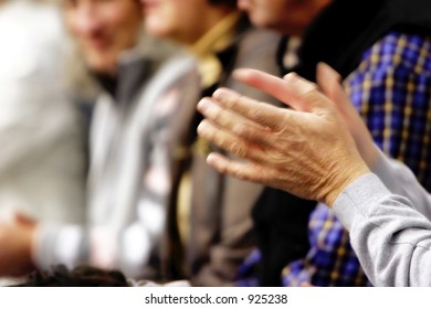 Blurred Motion Image (slow Shutter Speed) Of A Pair Of Hands Clapping In A Crowd.