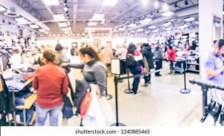 Blurred Motion Long Line Of Diverse Customers Waiting To Checkout At Apparel, Accessories Store In Texas, USA. Defocused Abstract Crowed People Retractable Stanchions Queue Barrier, Holiday Shopping