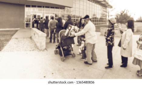 Blurred motion long queue of diverse multicultural people waiting at the entrance of immigration service office in Texas, America