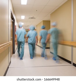 Blurred motion of medical team walking in hospital corridor