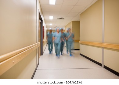 Blurred Motion Multiethnic Medical Team Walking In Hospital Corridor