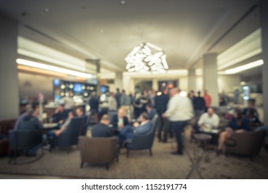 Blurred Motion People Have Happy Hour, Casual Business Meeting At The Lobby Of Luxury Hotel In San Francisco, California, USA. Blurry Abstract Background Industry Networking Event