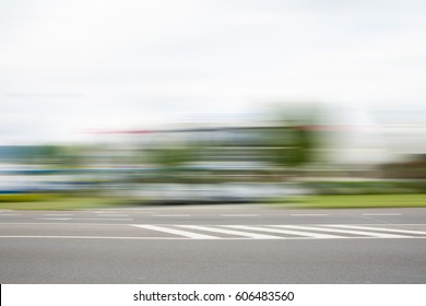 BLURRED MOTION OF QUICKLY MOVING CAR IN THE CITY STREET