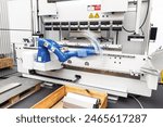 Blurred motion of robotic arm in factory. Assembly, machine tending, part transfer, pick and place robot.