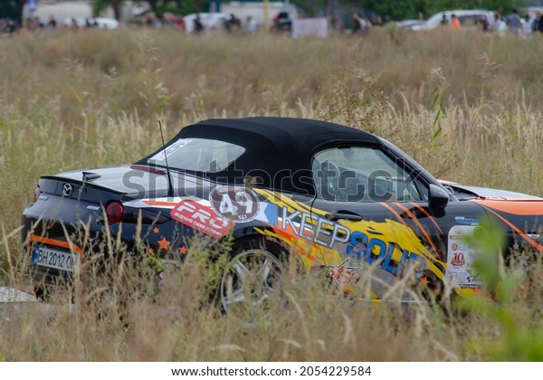 Blurred Motion. Sports car drives at\
high speed. Mazda MX-5 is a lightweight two-passenger roadster\
sports car.  Ukraine, Nikolaev - September 26,\
2021