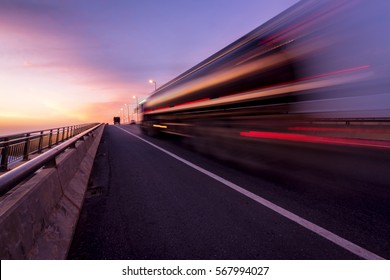  Blurred motion truck on the road with Sunset 
