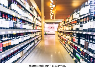 Blurred Motion Wine Shelves And Price Tags On Display At Grocery Store In Texas, USA. Defocused Rows Of Red, White Wine Liquor Bottles On Supermarket Shelf. Alcoholic Beverage Abstract Background