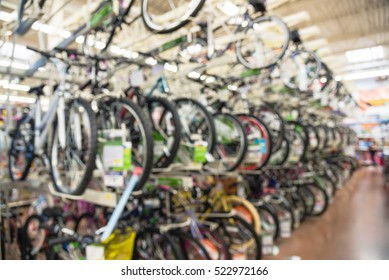 Blurred multiple rows of adult bikes hanging on rack at department store in Humble, Texas, US. Various modern road, touring, cyclocross, mountain, commuter bikes display. Healthy and active lifestyle. - Powered by Shutterstock