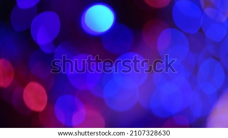 Blurred neon blue and pink bokeh defocused lights on dark background. (space for text or abstract background for design)