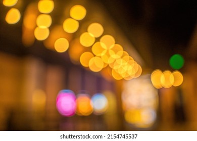 Blurred Night City Bokeh Glows Light Background Empty. Banner Candlelight Shines Yellow Gold Glitter Abstract. Design Background Celebration