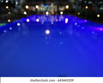 Blurred Night Light Reflection In Swiming Pool Blue Water In The Hotel