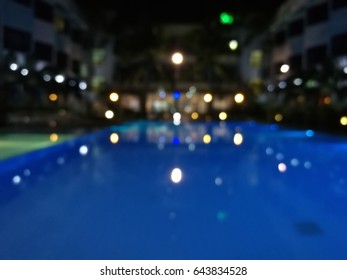 Blurred Night Light Reflection In Swiming Pool Blue Water In The Hotel