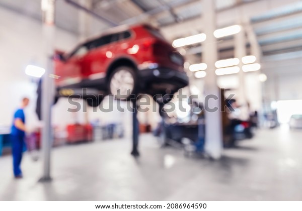 Blurred no focus background repair car service auto\
on lift.