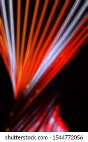 Blurred, No Focused, Abstract Festive Vertical Background With Red, Orange And White Led Stripes On A Black Background For Design On The Theme Of Christmas, New Year, Disco Style, EDM