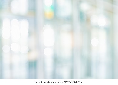 BLURRED OFFICE BACKGROUND, WHITE BUSINESS ROOM WITH WINDOW LIGHT REFLECTIONS, MODERN GLASSY DEFOCUSED INTERIOR  - Shutterstock ID 2227394747