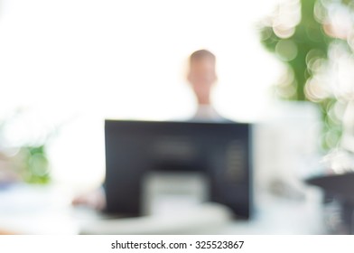 blurred office background , office worker at the computer, working day