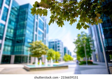 Blurred Office Building Exterior With Blue Glass Windows In Business City Center. Corporate Urban Buildings Blurry Background