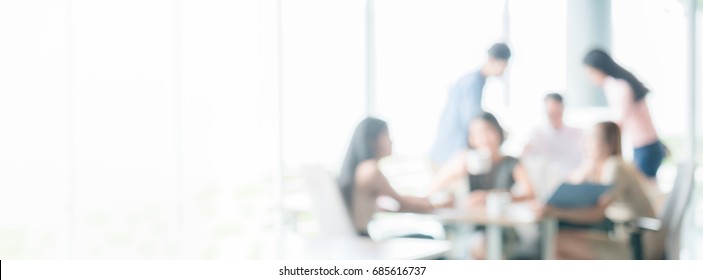 blurred office interior space with business people discussing brainstorming or relaxing background panoramic banner with copy space use us for background backdrop design graphics - Shutterstock ID 685616737