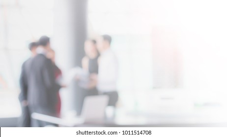 Blurred Office Interior Space With Businessman And Businesswoman Meeting Background With Copy Space.