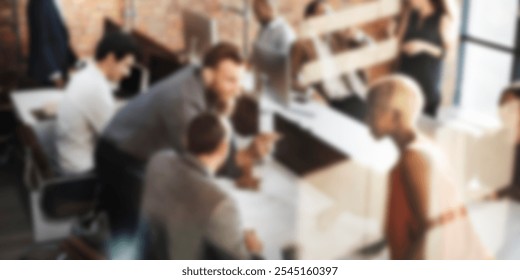 Blurred office scene with diverse team collaborating and meeting. Men and women, diverse ethnicities, engaged in meeting. Business workspace, teamwork, collaboration. Diverse business meeting concept. - Powered by Shutterstock