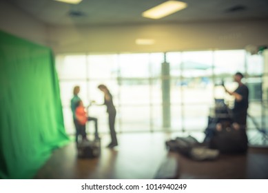 Blurred Open Space Onsite Photo Booth At Local Event In Irving, Texas, USA. Photographer With Assistant Taking Free Family Photos With Large Green Screen Backdrop, Equipments. Vintage Tone