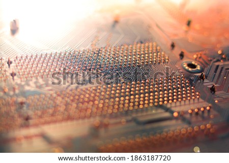 Blurred orange background in digital computer technology style. Trendy motherboard schematic texture with lines and dots. Shine and bokeh effect. Futuristic abstract patterns.