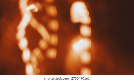 Blurred orange light patterns create an abstract visual effect with glowing elements