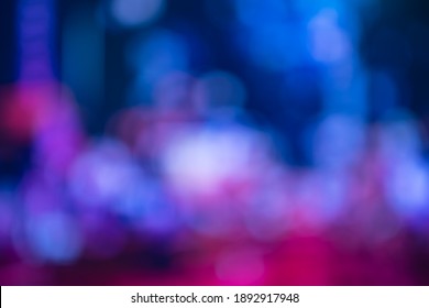Blurred, out of focus photo, night neons bokeh, vivid blue and purple colors, cyberpunk atmosphere. Amazing wallpaper backdrop. Night city street.
