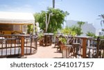 Blurred outdoor restaurant setting in lanzarote, canary islands, with tables and plants under the sunny spanish sky