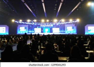 Blurred out-focus background of large scale gigantic seminar convention event. 