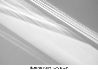 Blurred overlay effect for photo and mockups. Organic drop diagonal shadow and rays of light from window on a white wall. shadows for natural light effects
