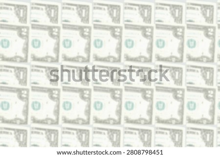 Blurred pattern of banknotes in denominations of one, two dollars