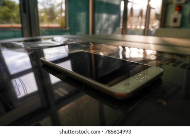 Blurred pattern of mobile phone on the machine cover in laboratory room, selective focus.
