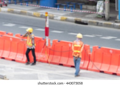blurred people construction workers working on residential street