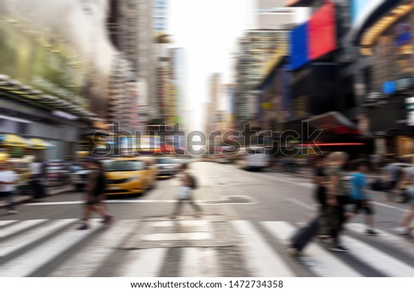 Blurred people crossing the
street