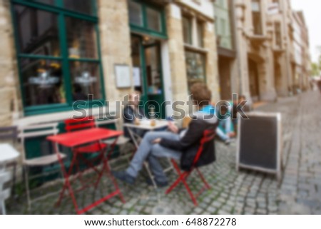  blurred People eat and sit in restaurant in scenery town, Ghent,Belgium.