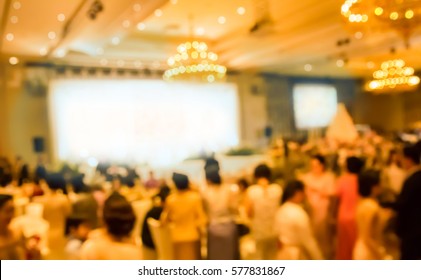 Blurred People Eating And Talking In Hotel Ballroom