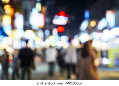 Blurred People Hipster Walking In Shopping Street Outdoor At Night