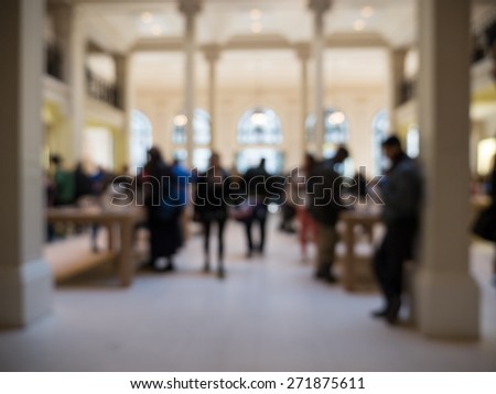 Blurred People inside Apple Store. Paris, France.