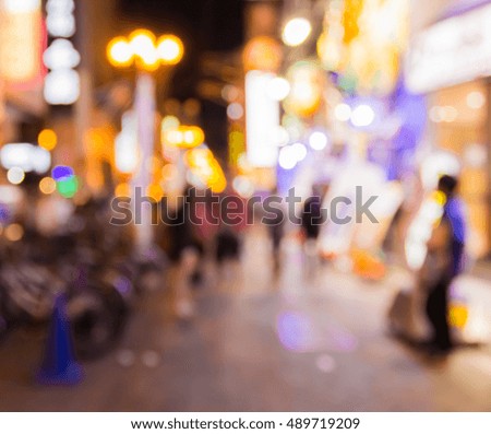 blurred people on  walking street in downtown at night