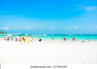 Blurred People On White Sand Beach With Blue Sea An Sky Background