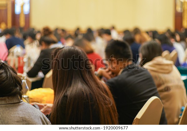 Blurred people sitting in business seminar\
room in hotel business\
background