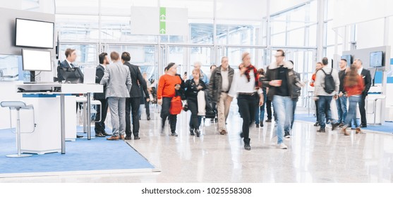 blurred people at a trade fair hall - Shutterstock ID 1025558308